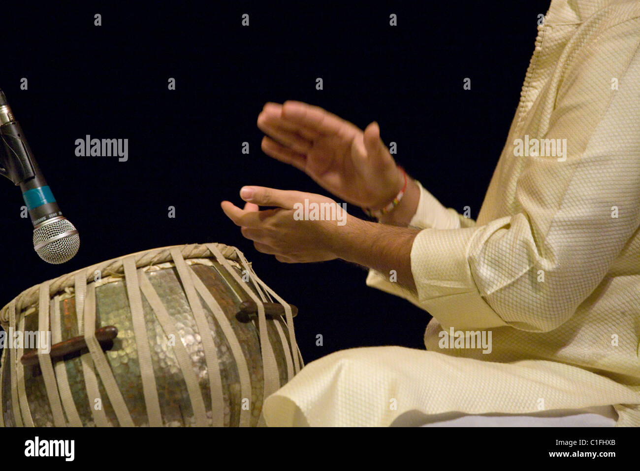 Classical Indian musicians perform onstage including famous sarod