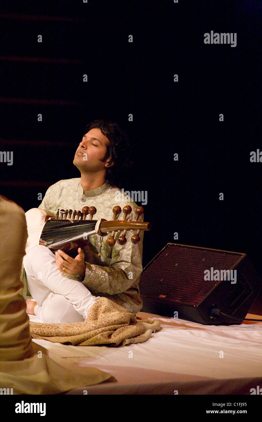 Classical Indian musicians perform onstage including famous sarod