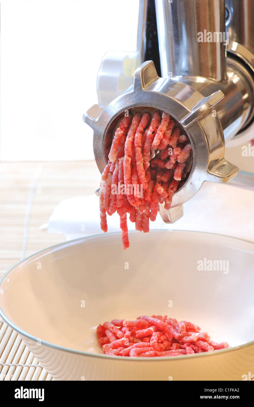 Meat grinder at work Stock Photo - Alamy