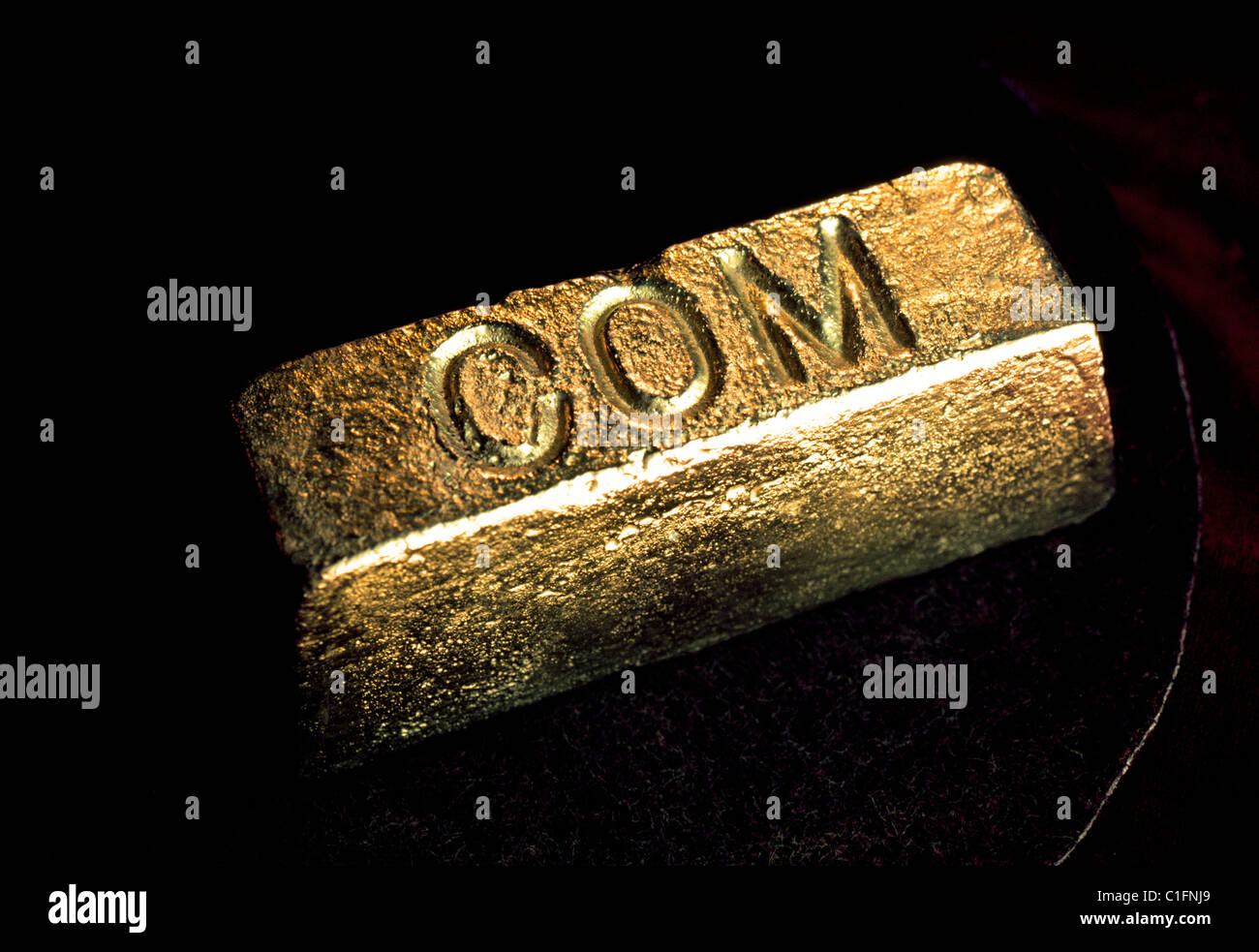 An ingot of gold molded and stamped by the Chamber of Mines (COM) at a Johannesburg gold mine in South Africa. Stock Photo