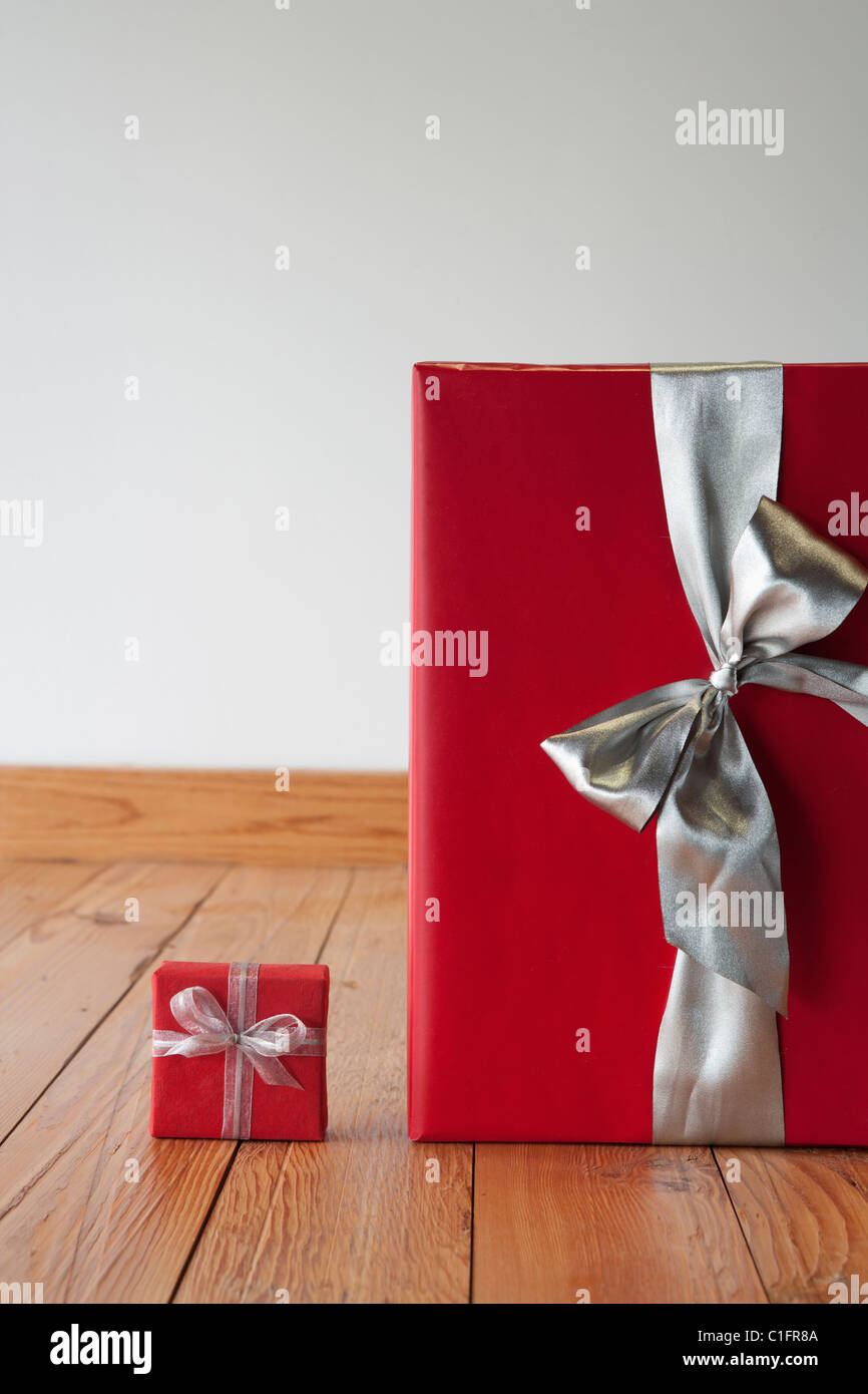 Large and small Christmas gifts on floor Stock Photo - Alamy