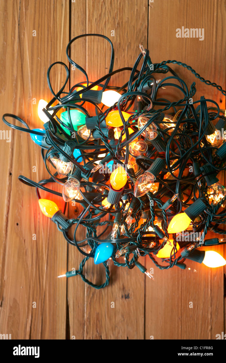 Glowing Christmas lights tangled on floor Stock Photo