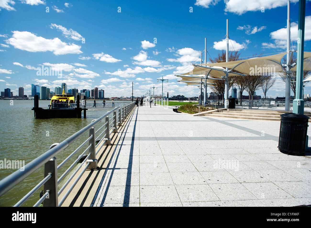 New York skyline under blue sky with a New York yellow water taxi Stock ...