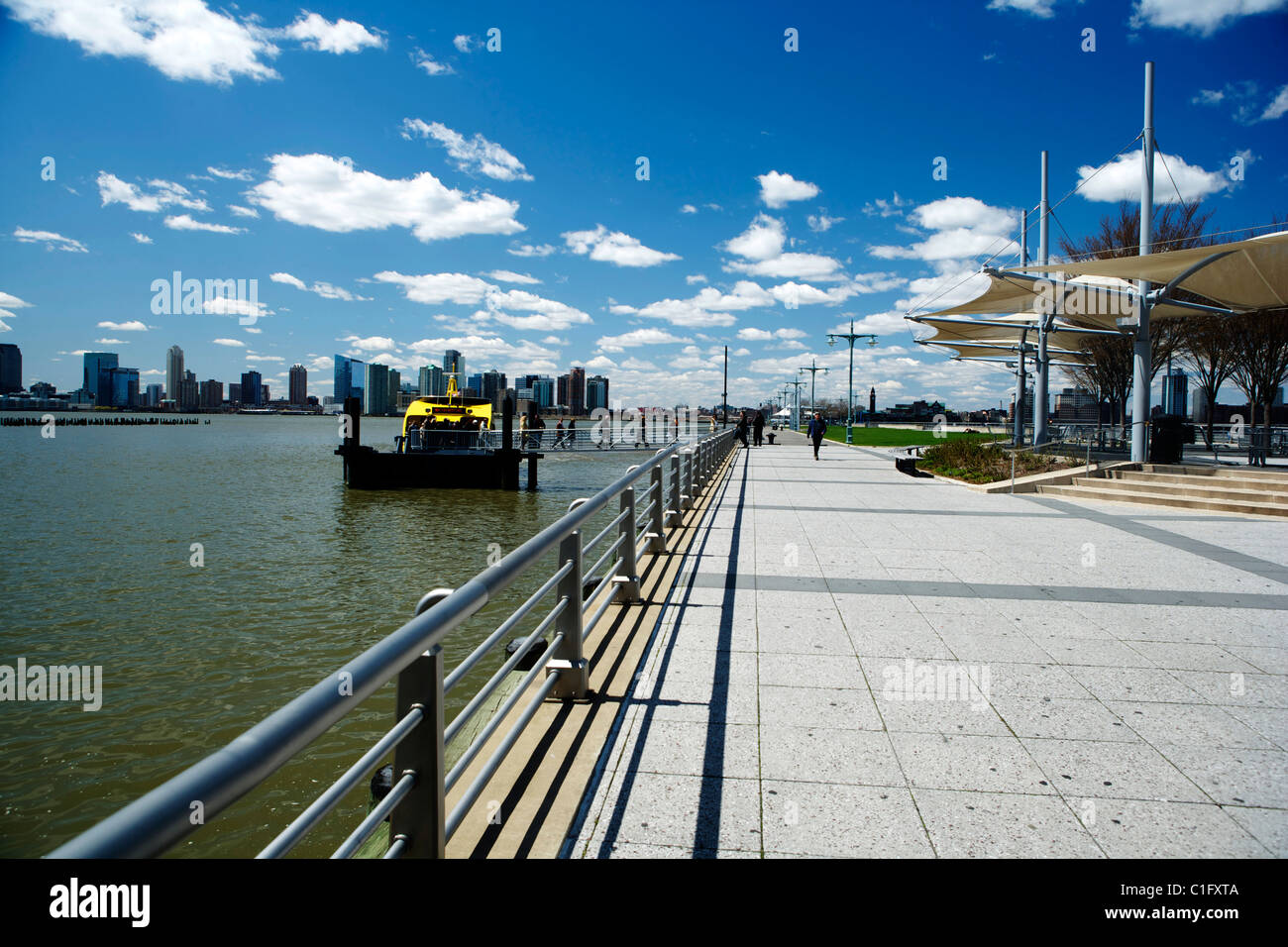 New York skyline under blue sky with a New York yellow water taxi Stock ...