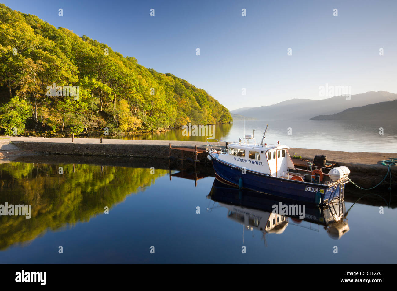 Boat moored in the small Inversnaid Hotel harbour on Loch Lomond, Loch Lomond and The Trossachs National Park, Scotland Stock Photo