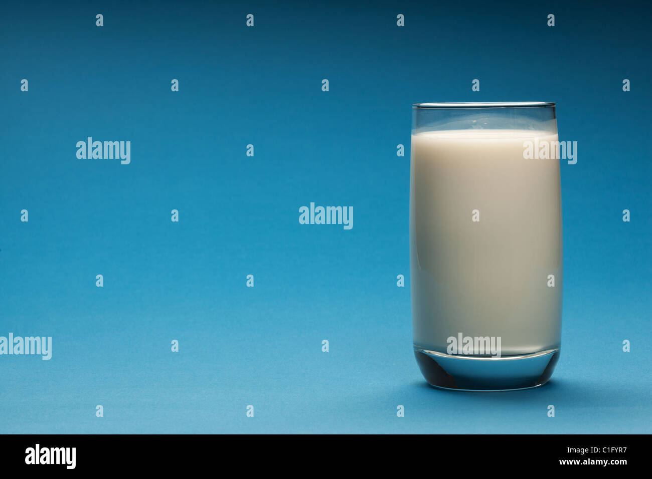 Glass of milk on a blue background. Stock Photo