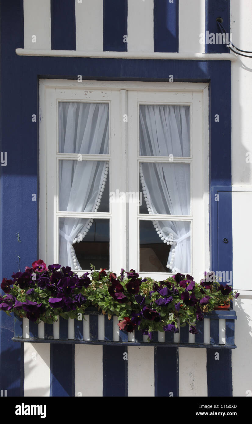 Holiday home window in traditional striped fisherman's cottage, Costa Nova, central Portugal Stock Photo