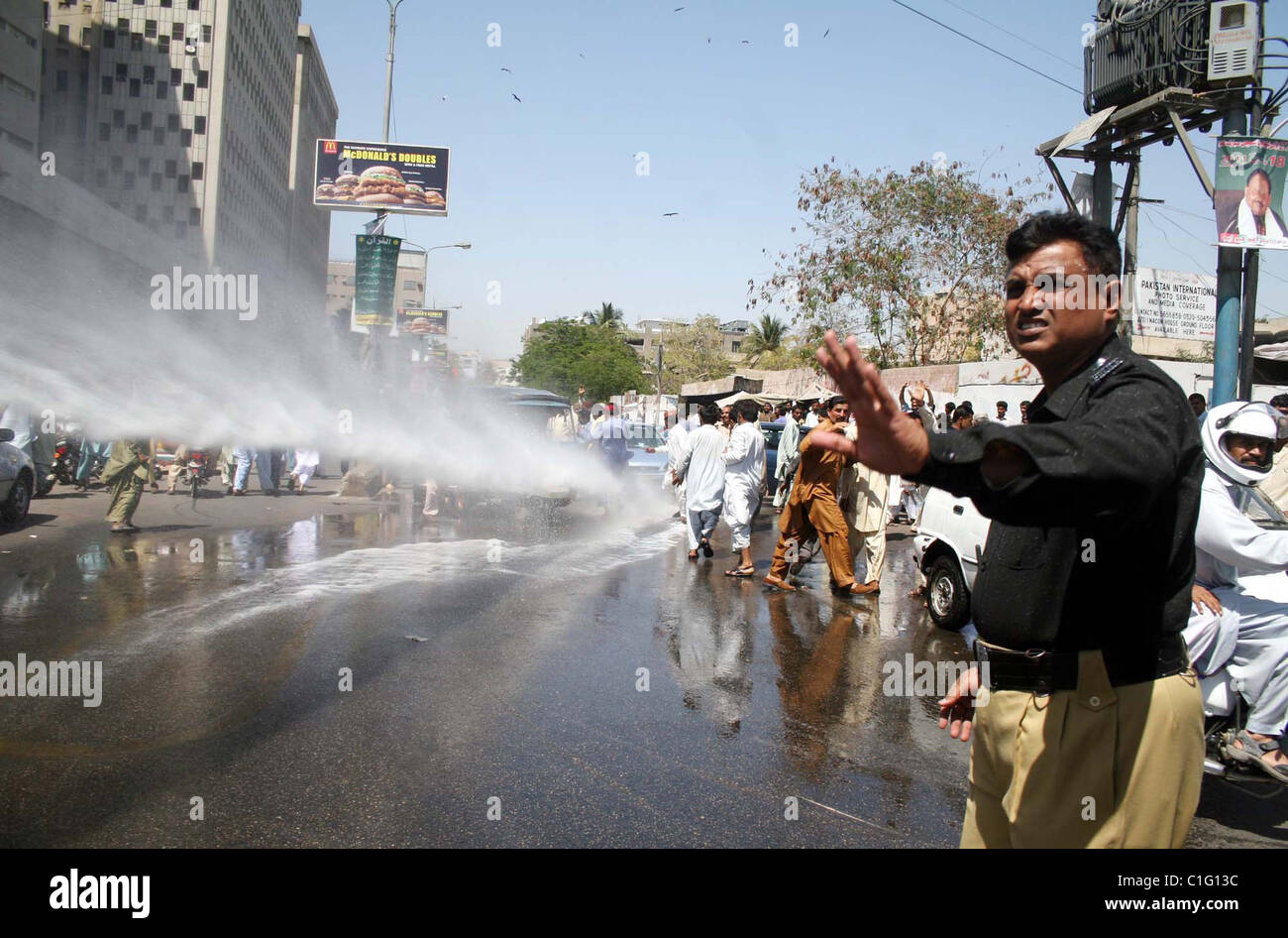 Police official directs water-canon-vehicle to disperse protesters during protest rally of All Sindh Lower Staff Association Stock Photo