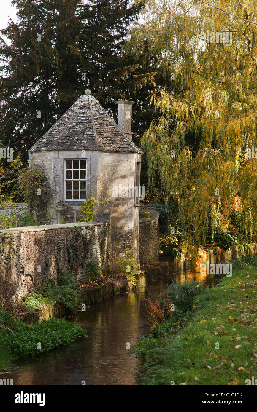A round tower, stream and footpath in the charming Cotswold village of