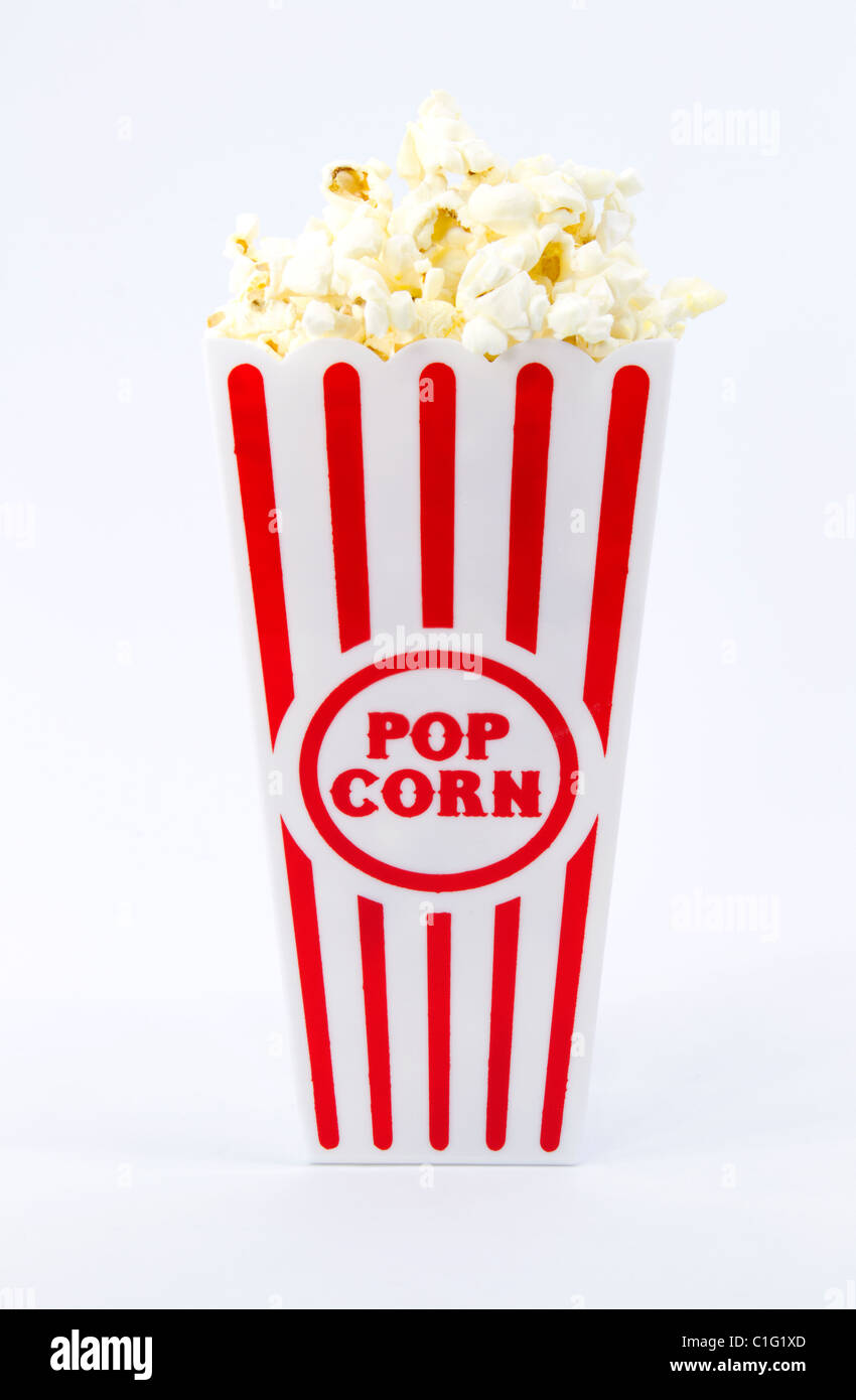 Popped popcorn piled high in red and white striped container Stock Photo Alamy