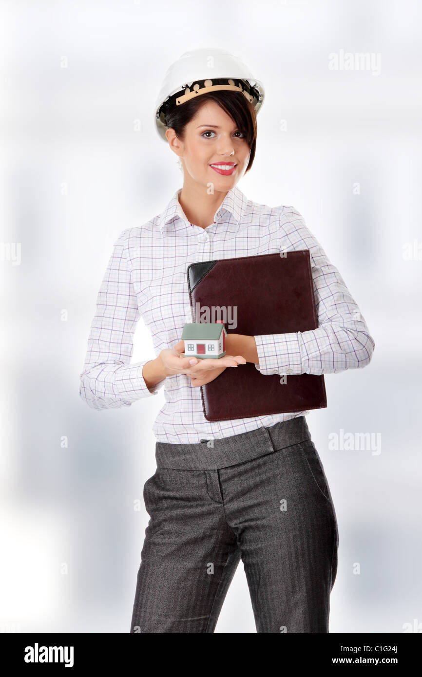 Young businesswoman holding house model Stock Photo - Alamy