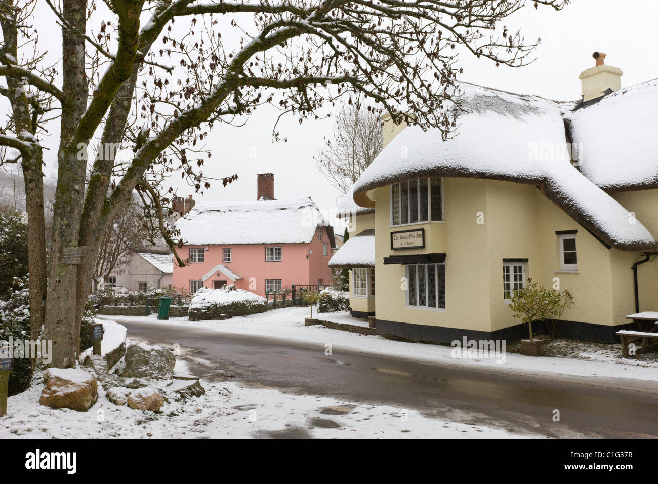 Snow covered country pub and cottages in the village of Winsford, Exmoor National Park, Somerset, England. Stock Photo