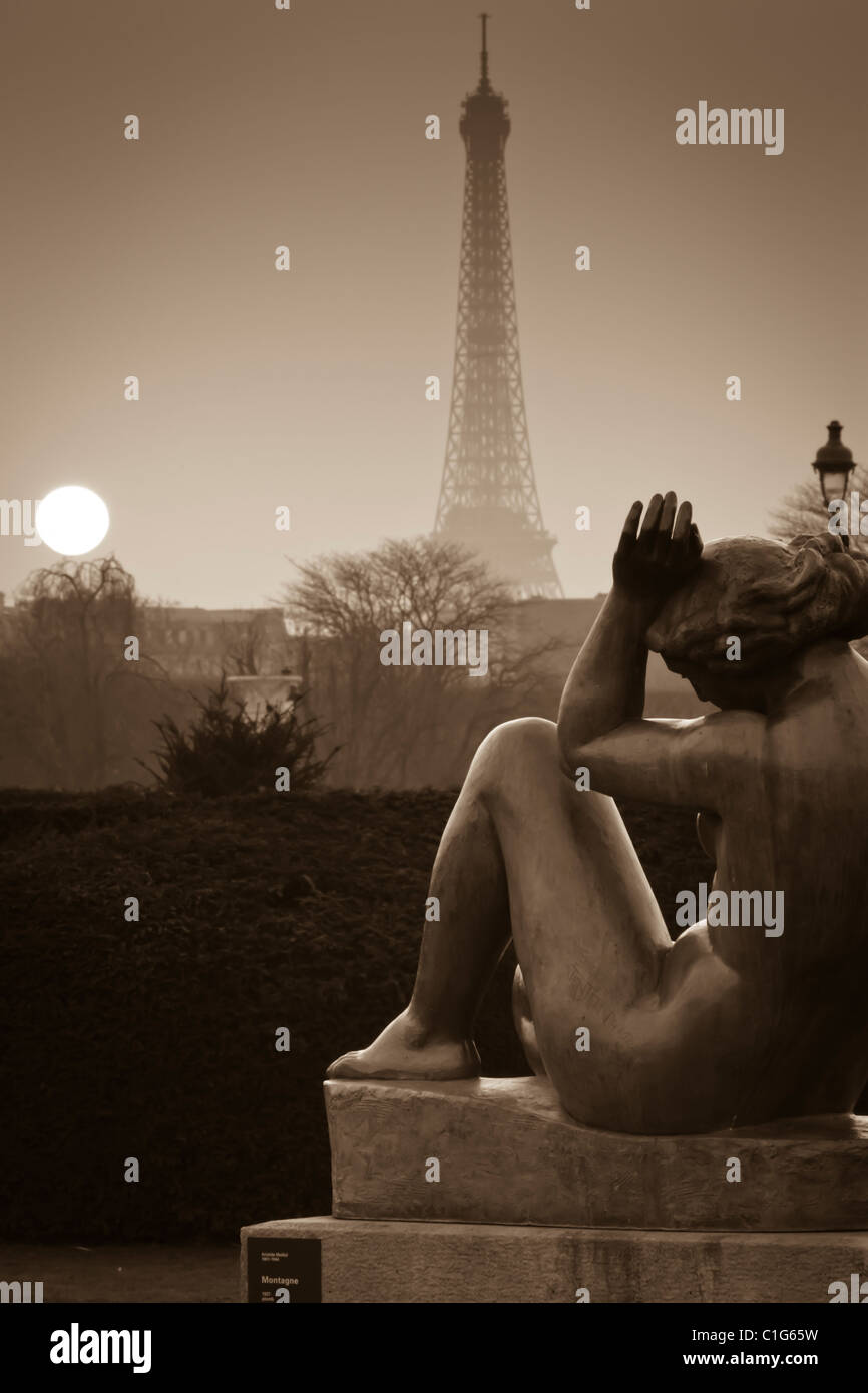 Eiffel Tower and sculptures at sunset from Tuileries Garden. Paris, France. Stock Photo