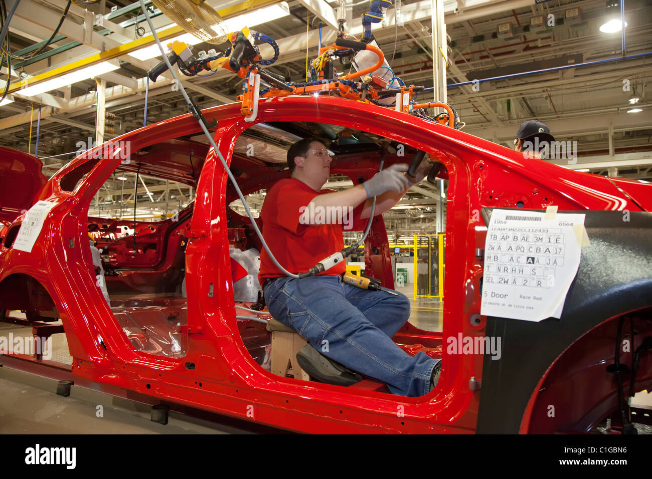 Workers assemble the 2012 Ford Focus at Ford Motor Co.'s Michigan Assembly Plant. Stock Photo
