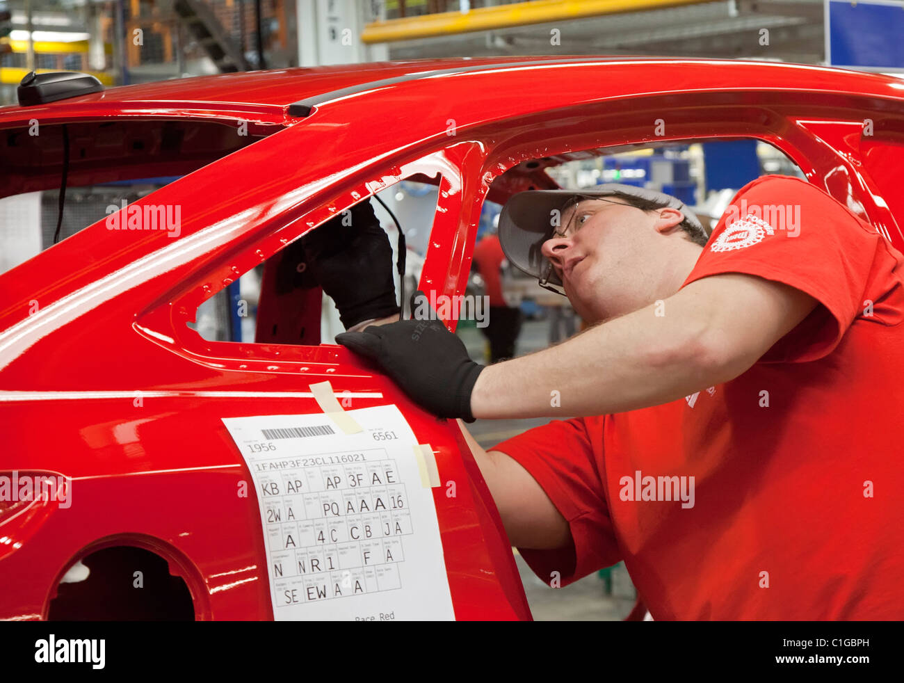 Workers assemble the 2012 Ford Focus at Ford Motor Co.'s Michigan Assembly Plant. Stock Photo
