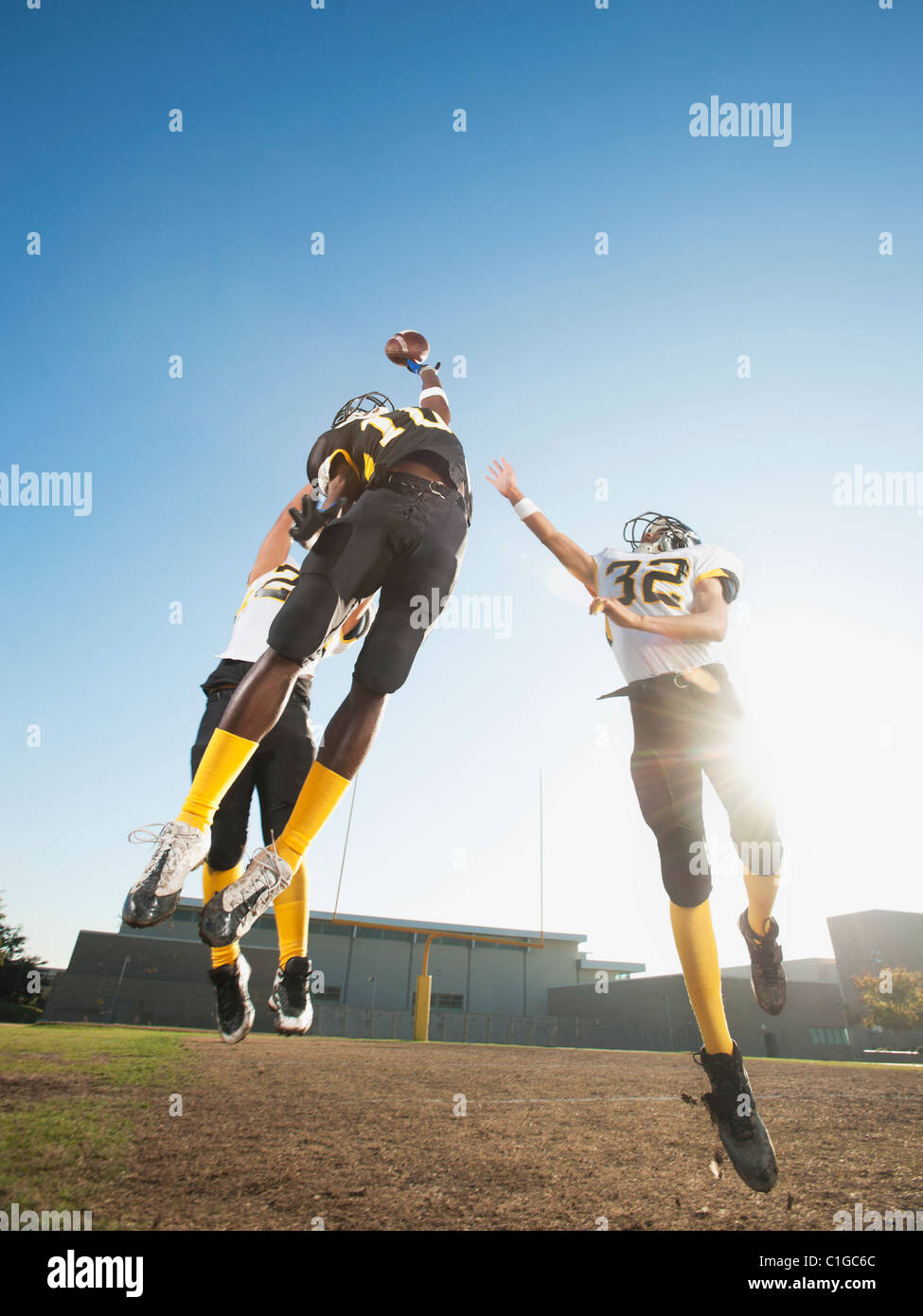 Football player catching ball on football field Stock Photo Alamy
