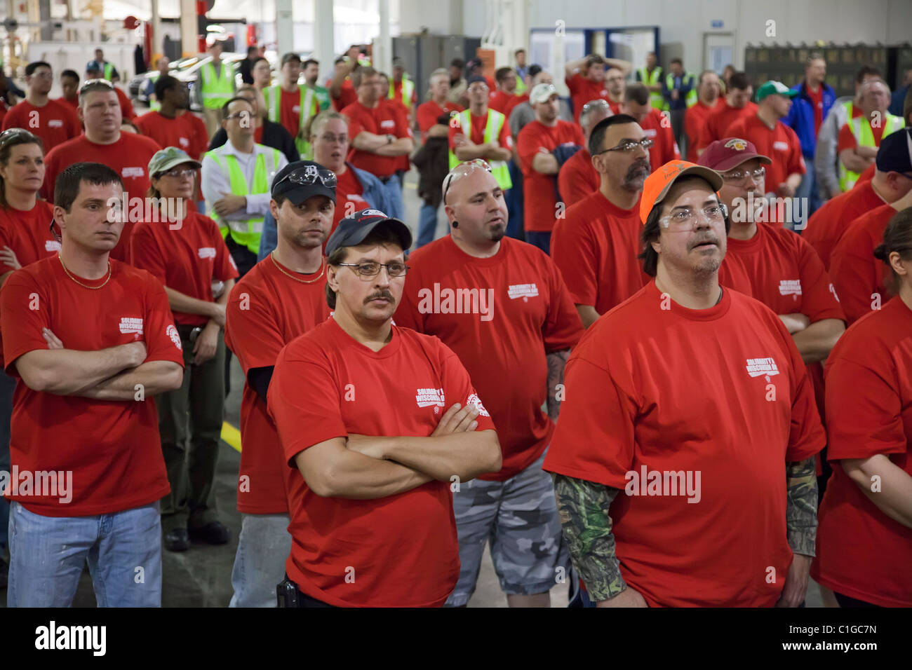 Auto Workers at Ford Motor Co.'s Michigan Assembly Plant wear red t-shirts in solidarity with public employees in Wisconsin Stock Photo