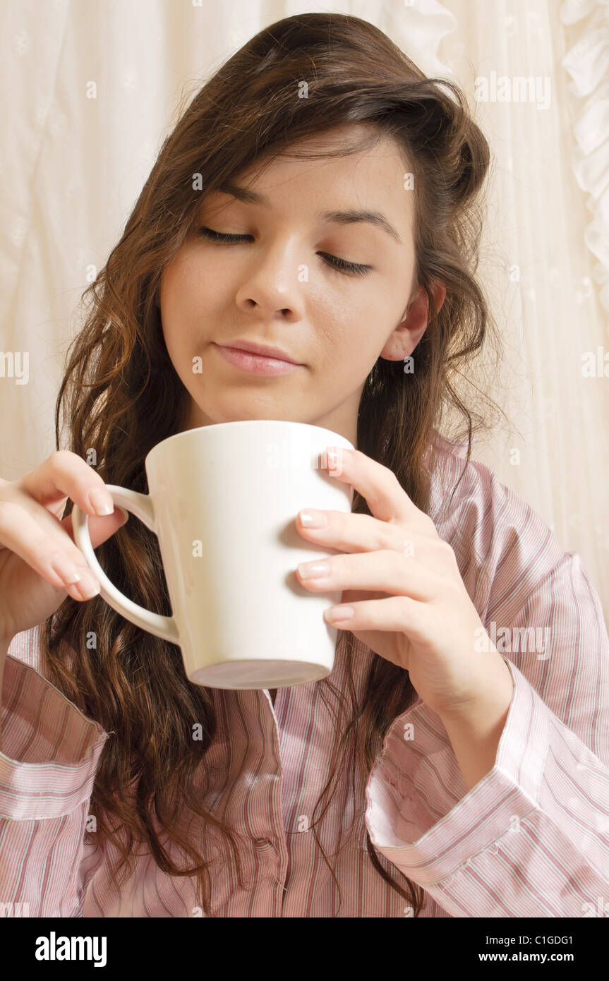 Girl drinking coffee in bed Stock Photo Alamy