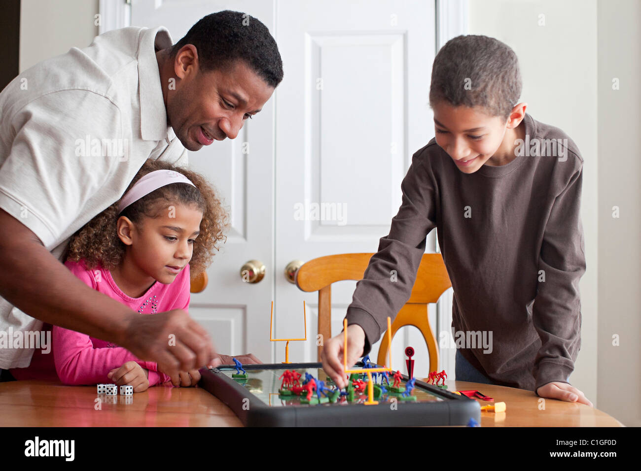 Family playing board game together Stock Photo