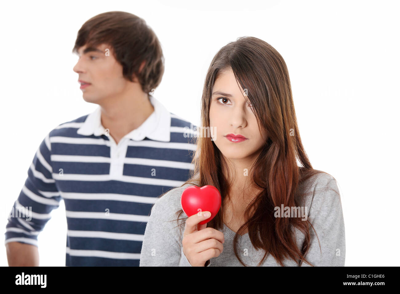Young couple with red heart. Isolated on white background Stock Photo ...
