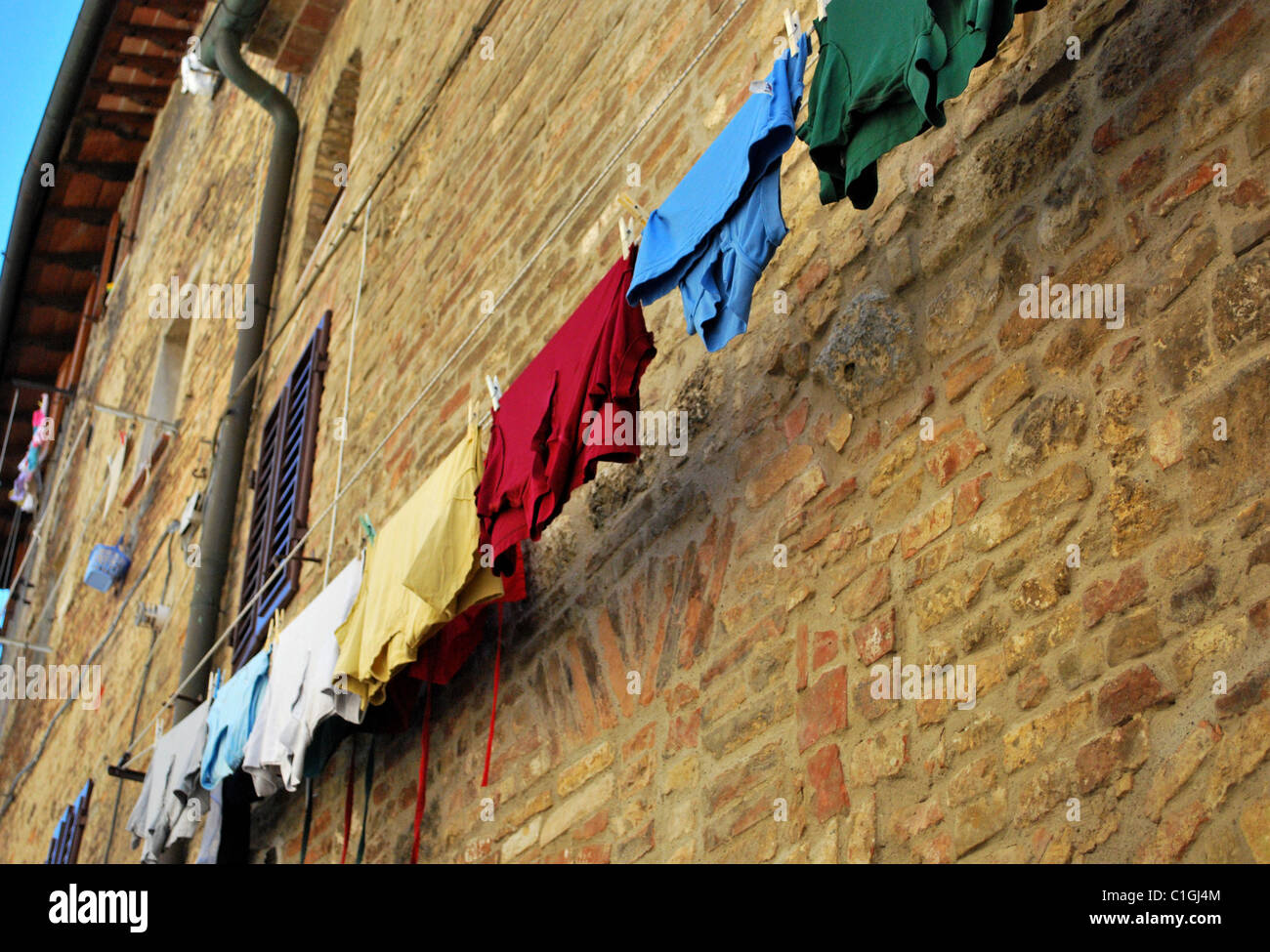 Colourful t-shirts drying in the sun, Tuscanny, Italy June 2008 Stock Photo