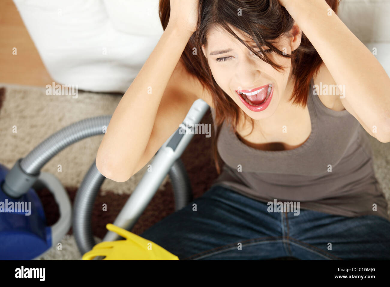 Young woman hates cleaning home. Stock Photo