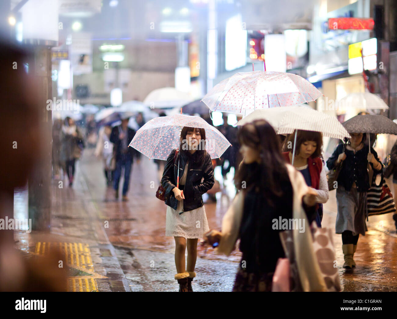 Woman walk in the street with umbrella, Shibuya, Tokyo, Japan. Stock Photo