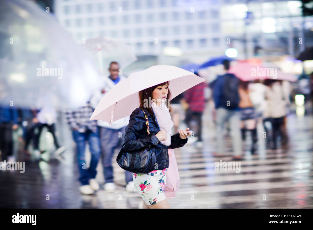 Pedestrians cross the busiest intersections in Shibuya, Tokyo, Japan. Stock Photo