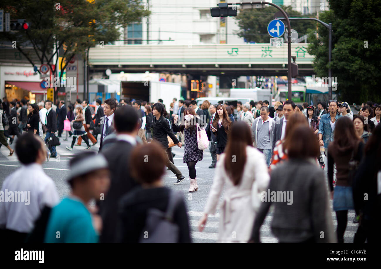 Pedestrians cross the busiest intersections in Shibuya, Tokyo, Japan. Stock Photo