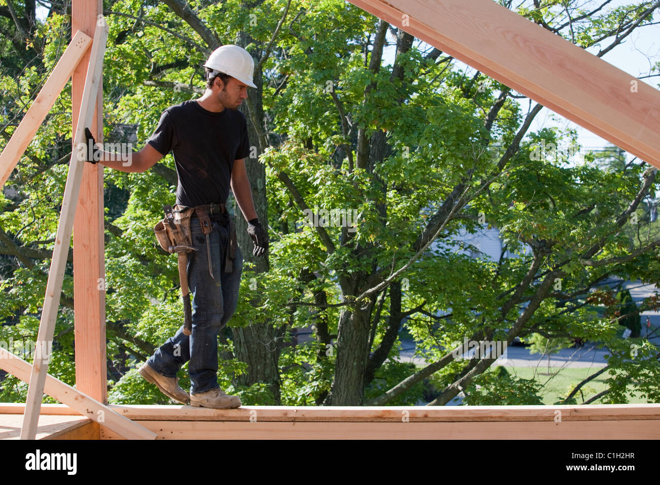 Carpenter on roof framing Stock Photo Alamy