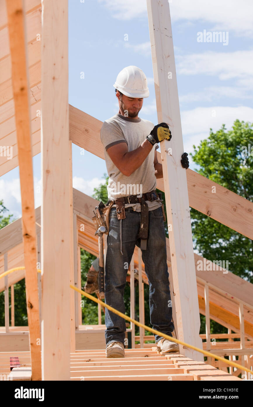 Carpenter holding a roof rafter Stock Photo