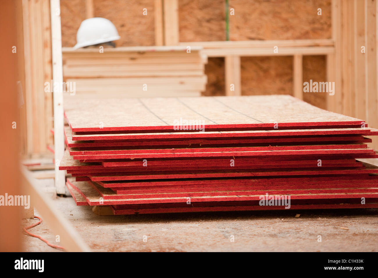 Stack of sheathing at a house under construction Stock Photo