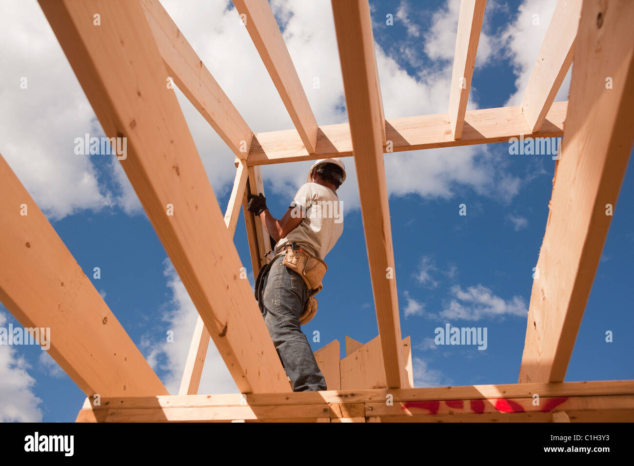 Carpenter adjusting roof rafters Stock Photo - Alamy