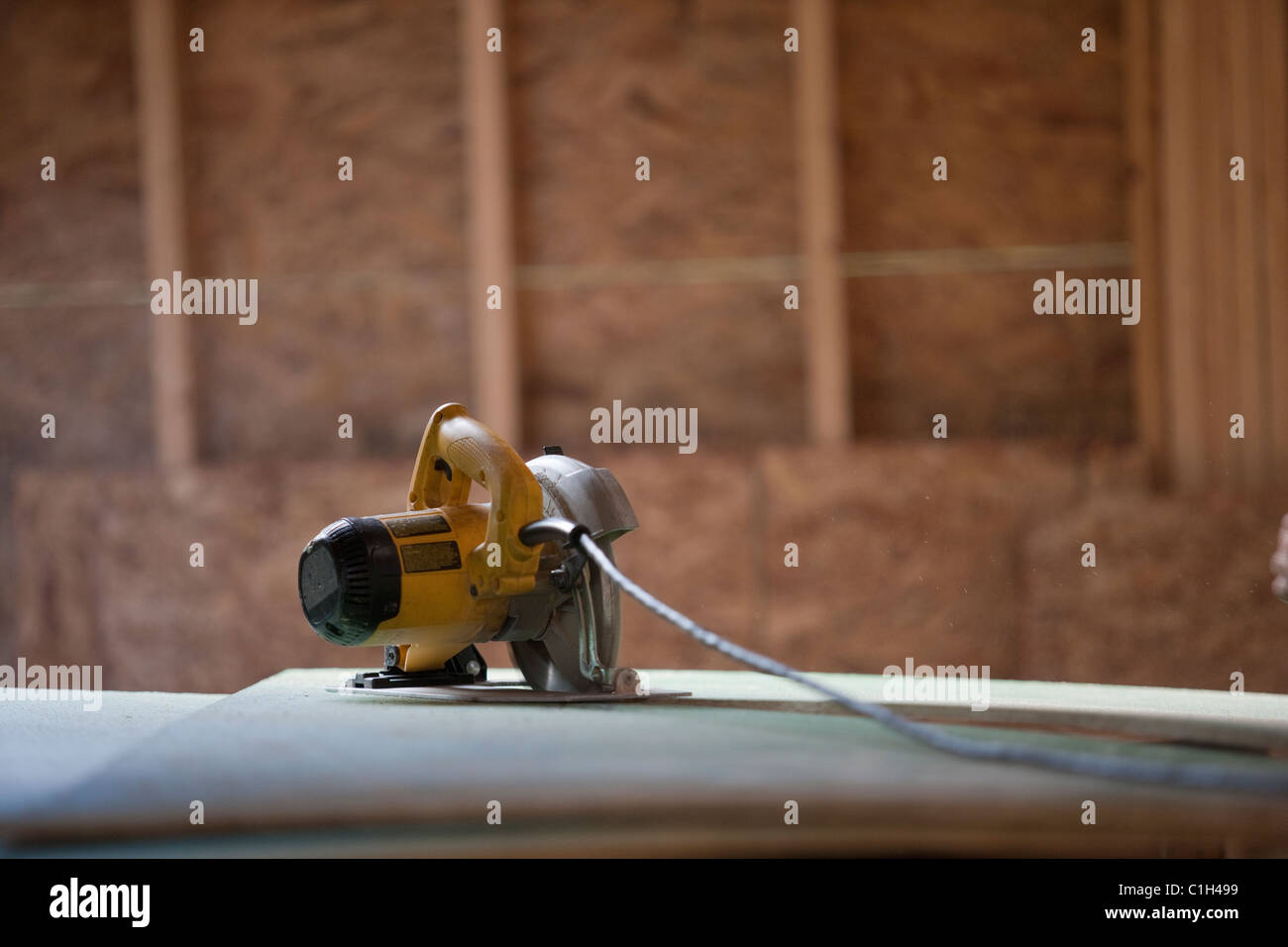 Circular saw on roofing sheathing at a house under construction Stock