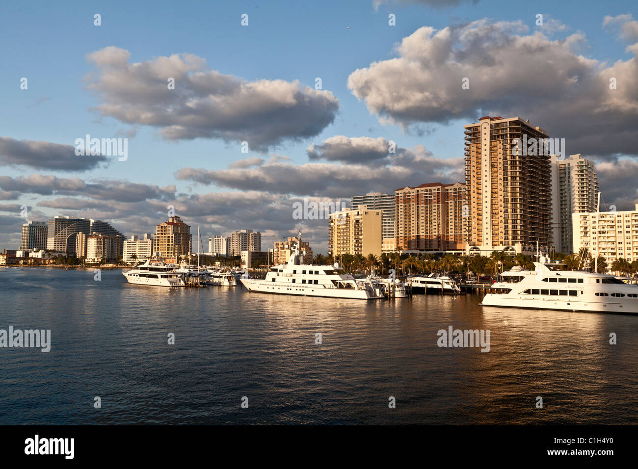 Luxury yachts docked in intercoastal waterway with Fort Lauderdale hotels in background. Stock Photo