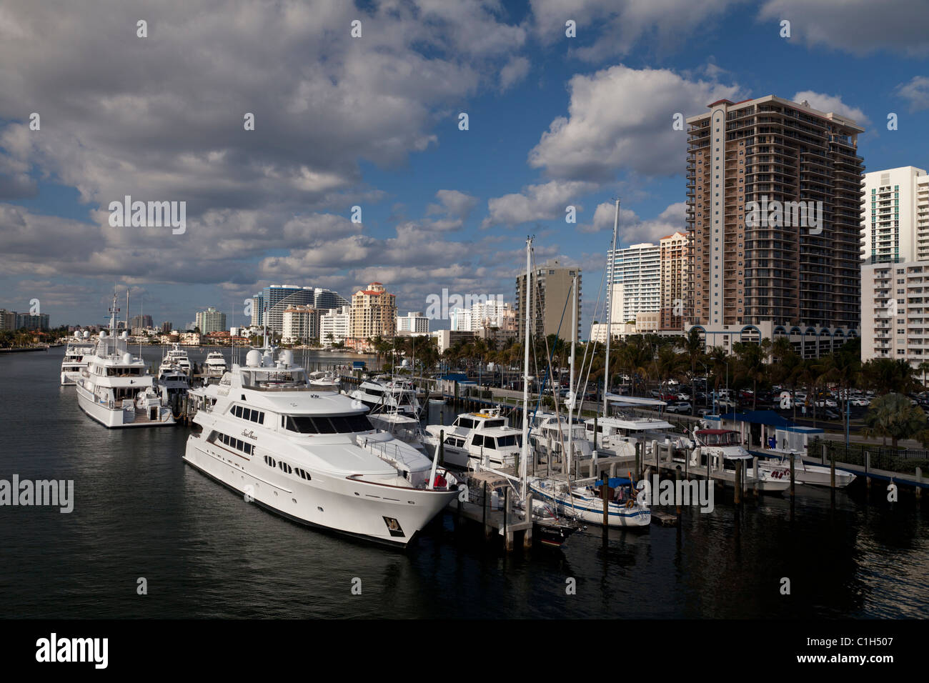 Luxury yachts docked in intercoastal waterway with Fort Lauderdale hotels in background. Stock Photo