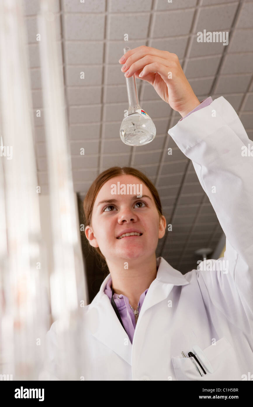 Scientist examining a flask in the laboratory of water treatment plant