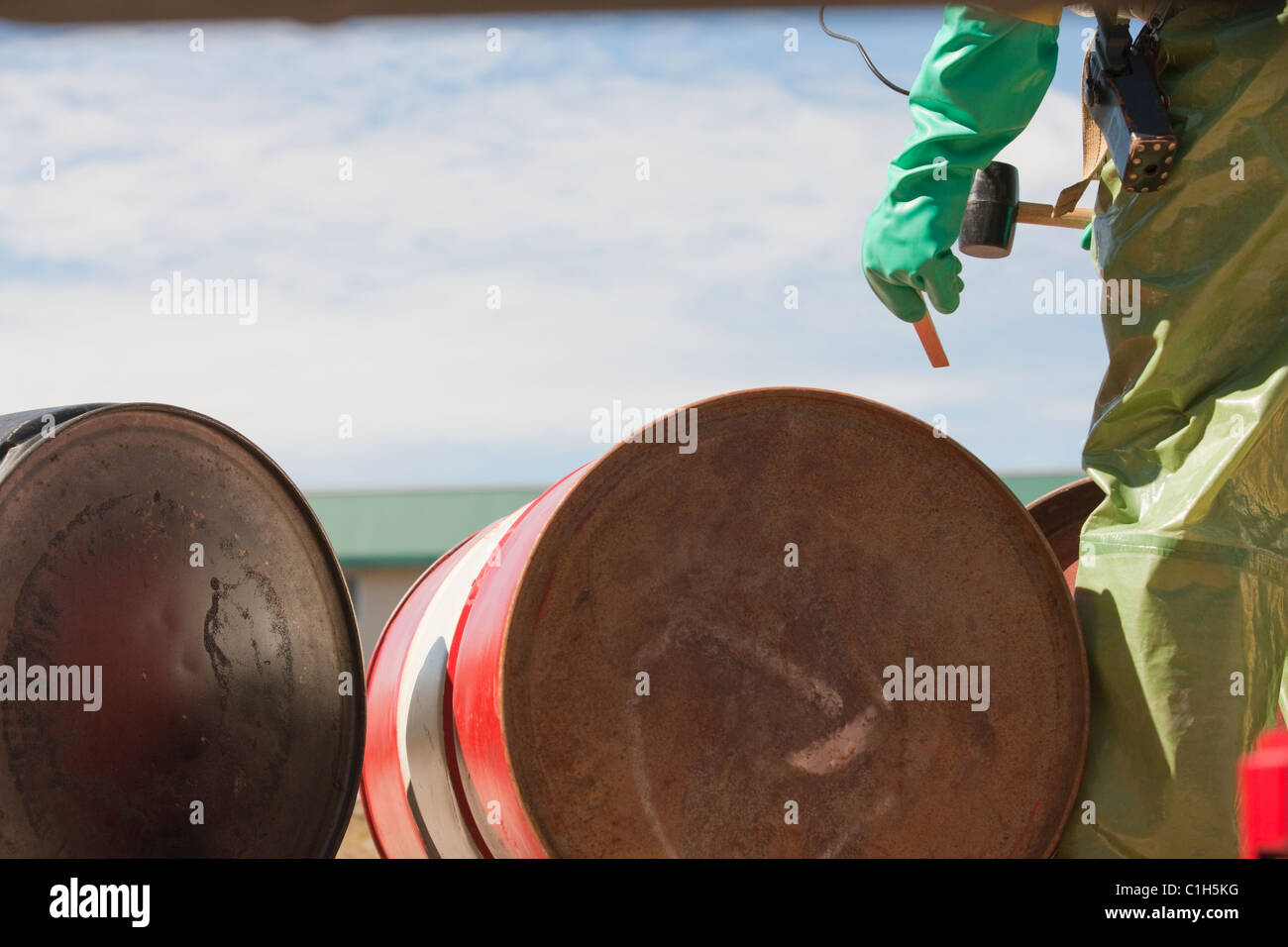 HazMat firefighter plugging a drum Stock Photo Alamy
