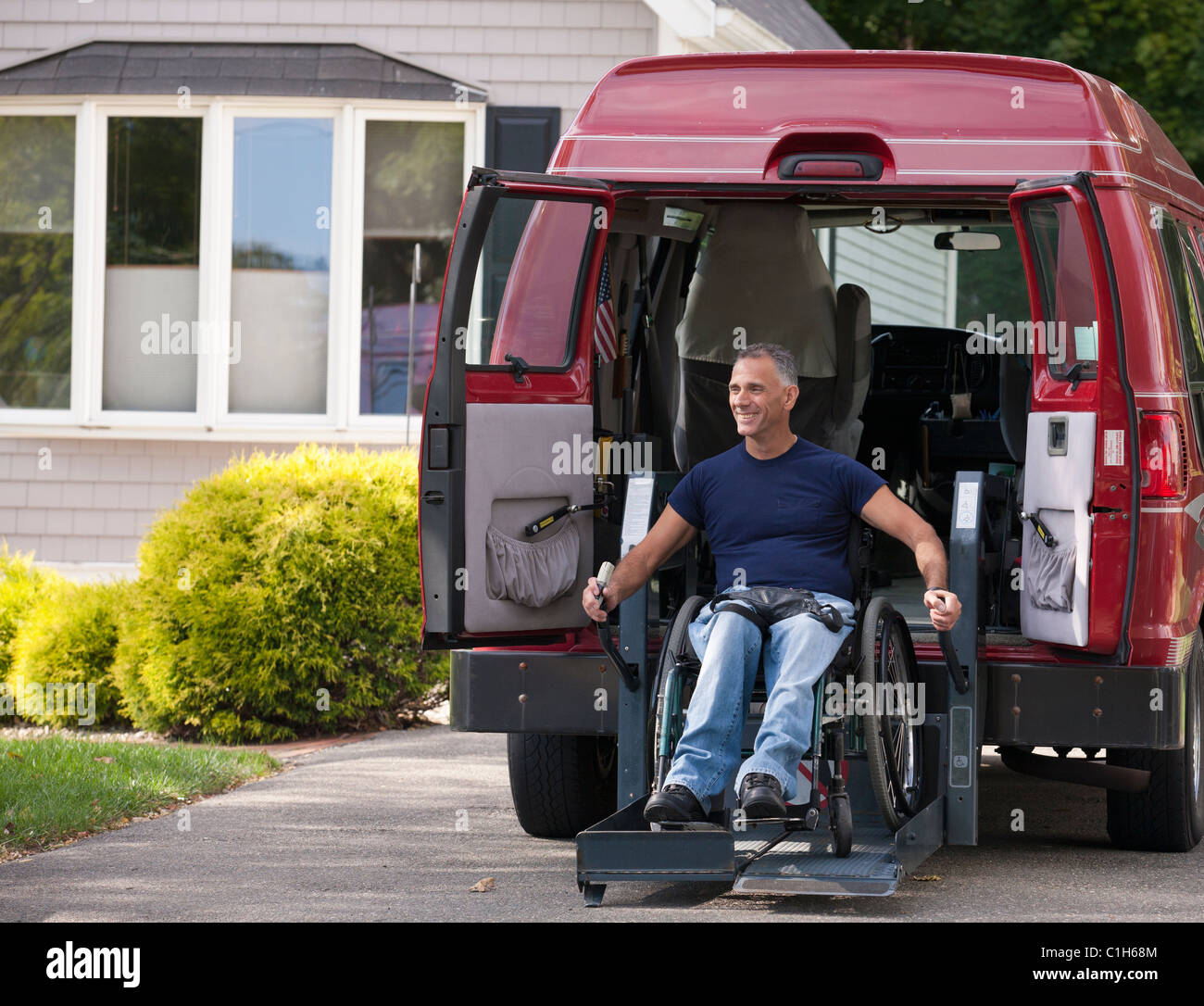 Man with spinal cord injury in a wheelchair getting in his accessible ...