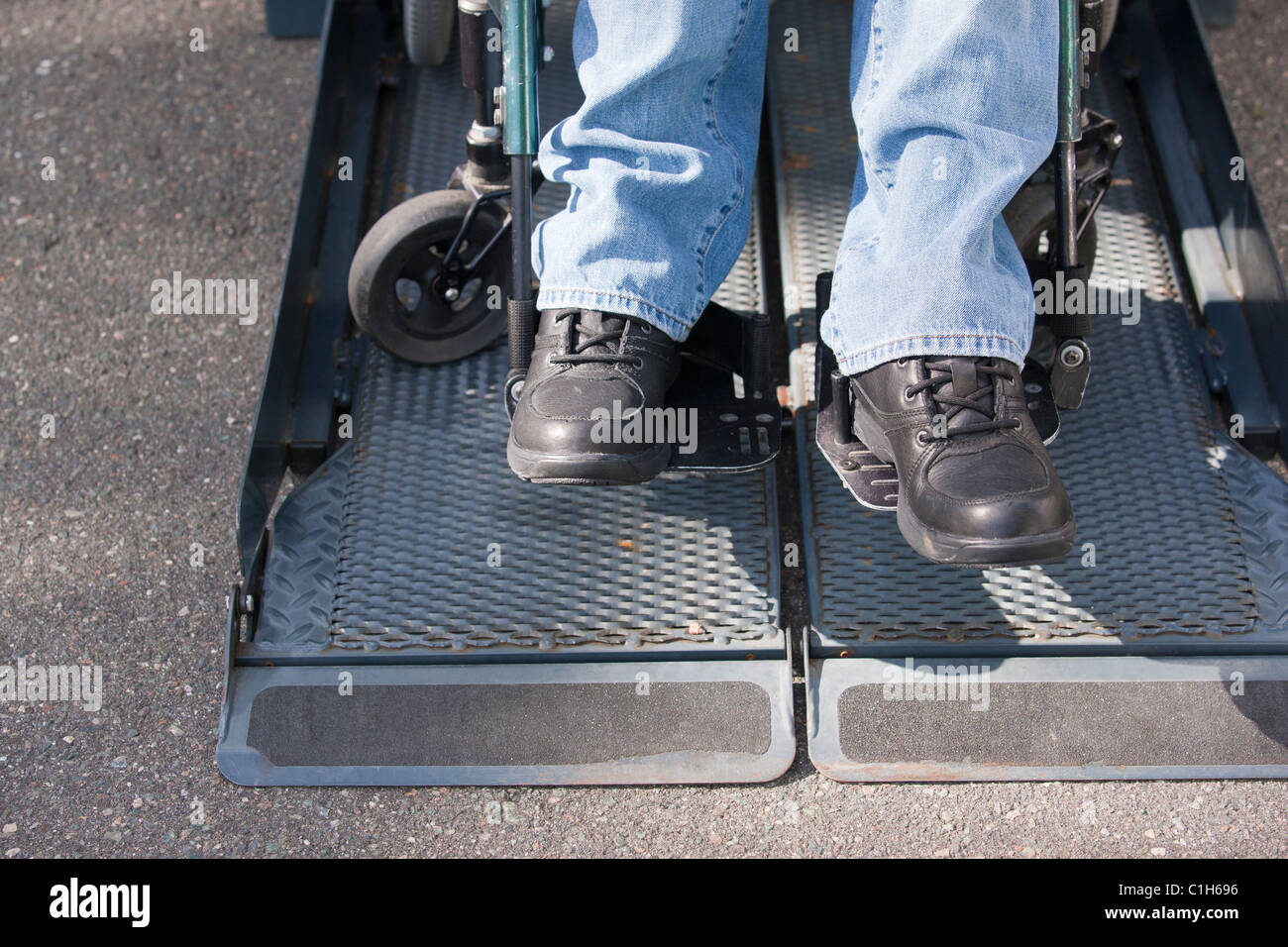 Man with spinal cord injury in a wheelchair near an accessible van ...