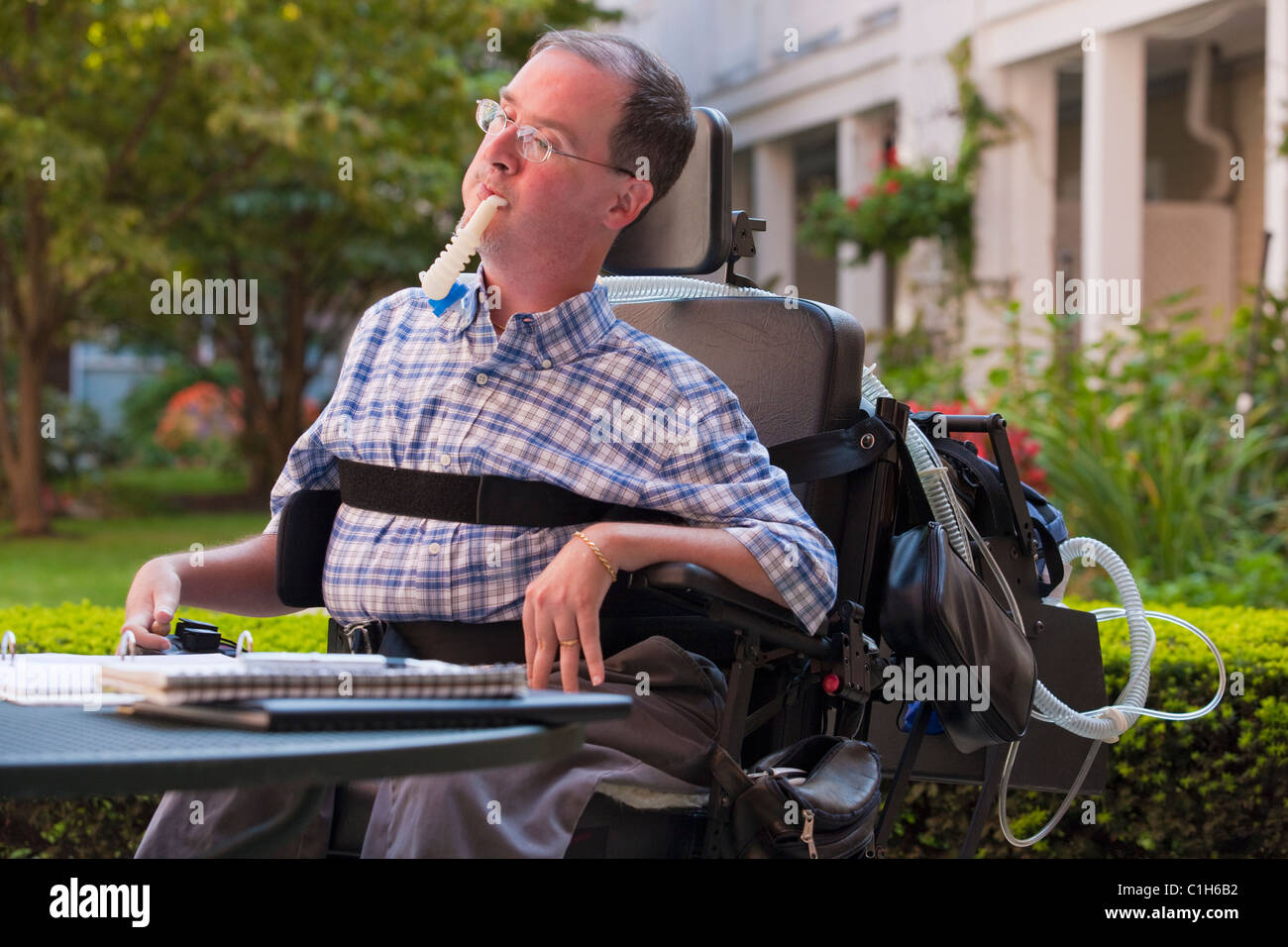 Businessman with Duchenne muscular dystrophy using breathing Stock