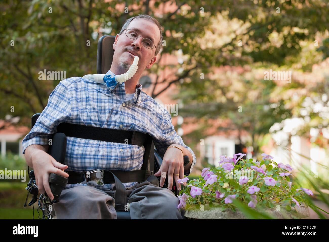 Man with Duchenne muscular dystrophy sitting in a wheelchair with a