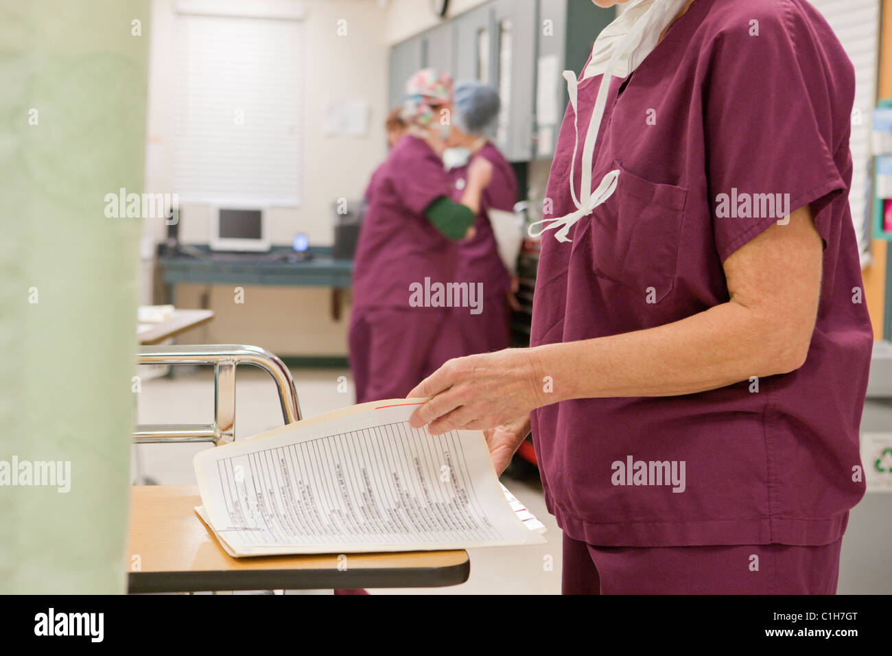 Female nurse examining a medical report after surgery Stock Photo Alamy