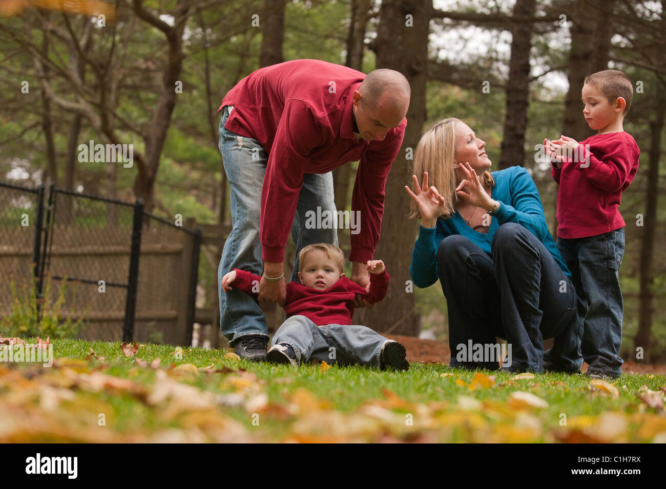 Woman signing the word 'Family' in American Sign Language while playing