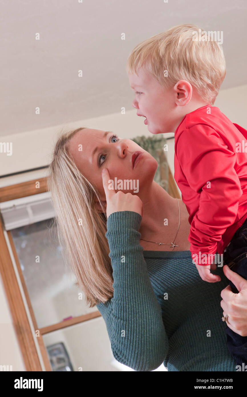 Woman signing the word 'Cry' in American Sign Language while communicating with her crying son