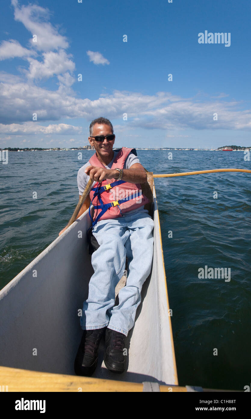 Man with spinal cord injury outrigger canoeing in the sea Stock Photo