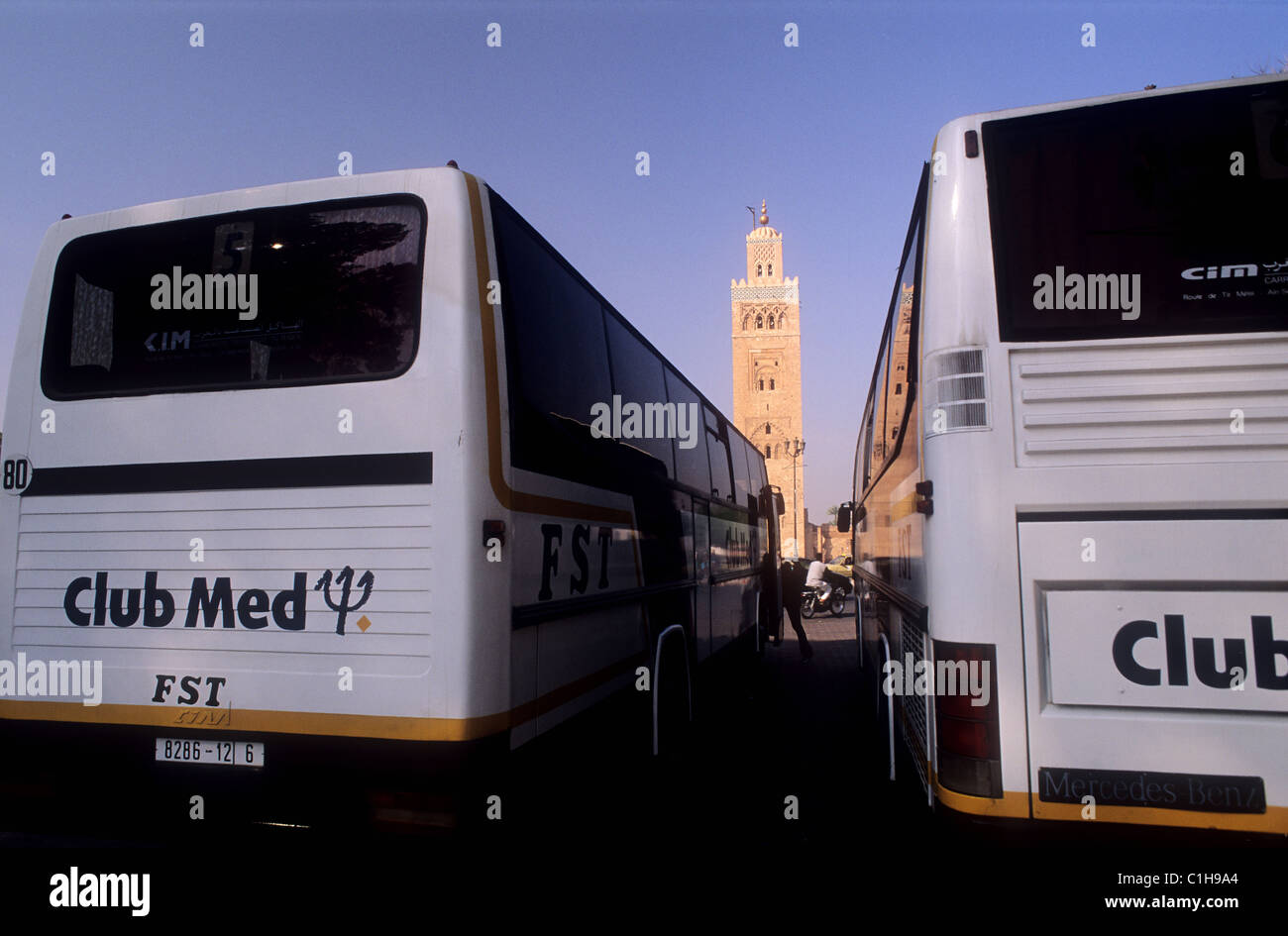 Morocco, Marrakesh, Club Med bus with Koutoubia mosque in background Stock Photo