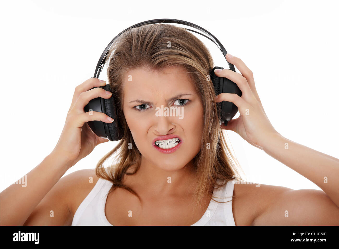 Emotional portrait of teen girl listening aggressive music in ...