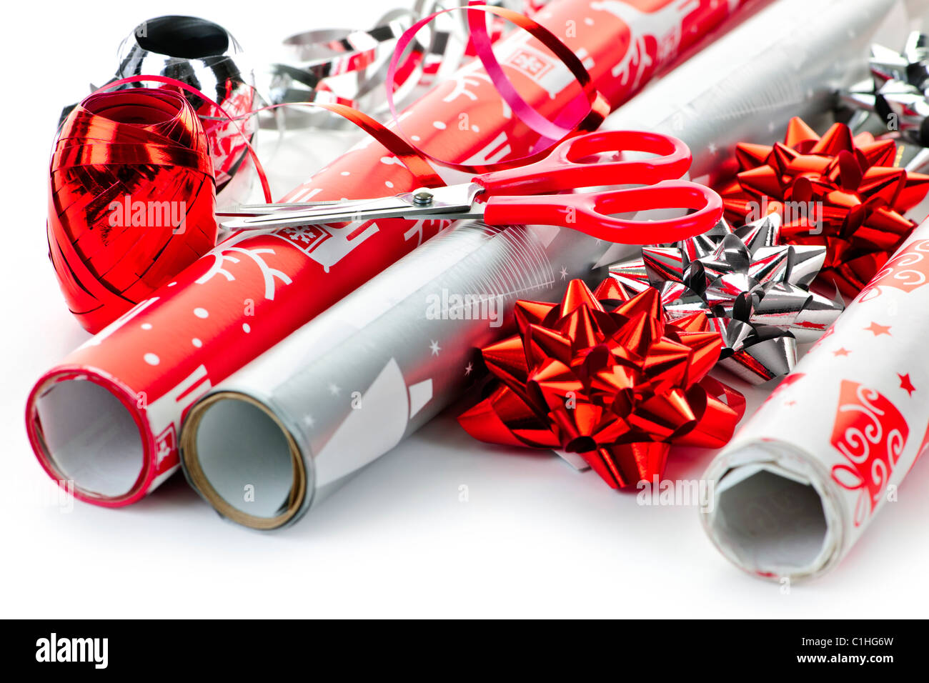 Getting organized: Paper wrap with Christmas theme, scotch tape, scissors  and ribbons for present wrapping, viewed from above Stock Photo - Alamy