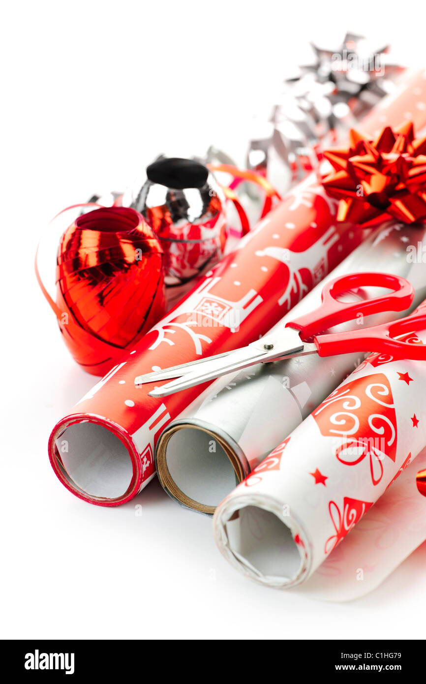 Rolls of Christmas wrapping paper with ribbons, bows and scissors Stock Photo
